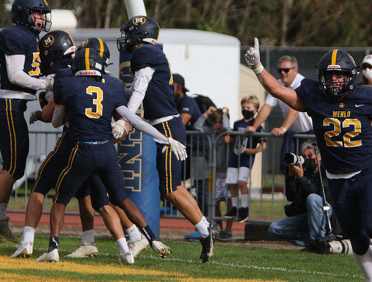 Menlo teammates celebrate Sam Scola's touchdown on a fumble recovery