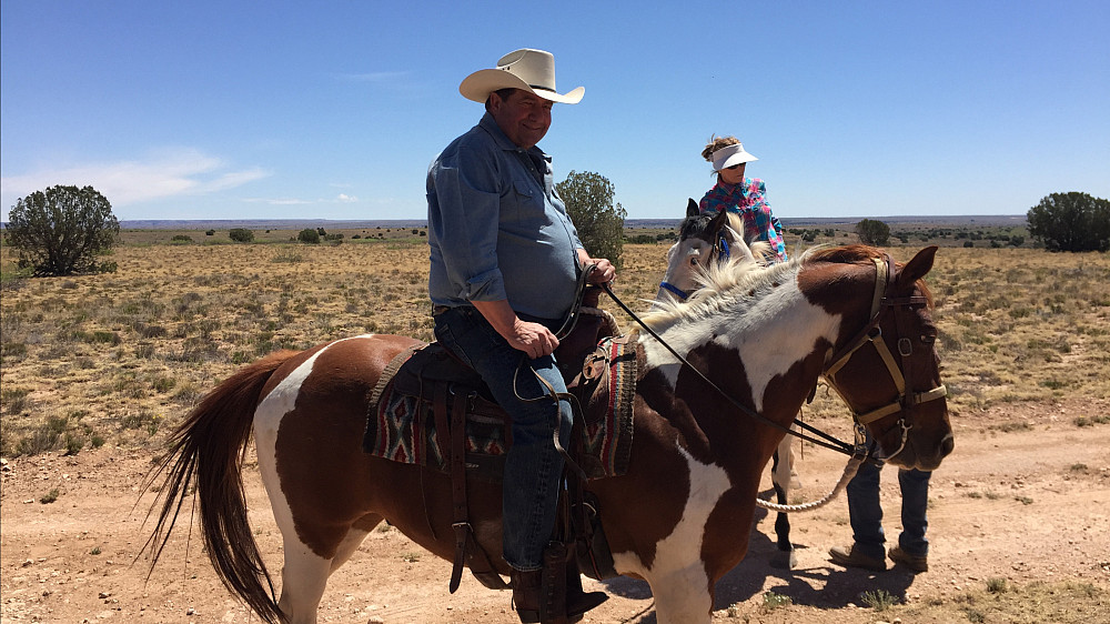 Greg Eaton '65 astride a horse while on a trip he took with multiple Menlo classmates in 2018.