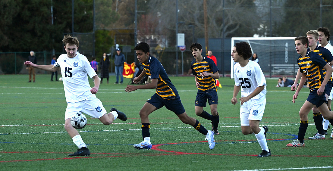 Menlo's Andre Gonzalez Lombera (14) defends Carlmont's Hayes Goboury in Tuesday's game.