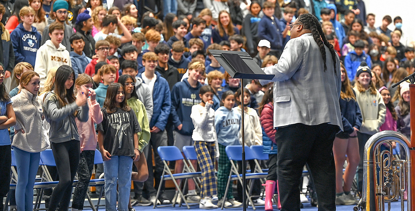 Richard White (Raw Tuba) speaks at an all-school assembly.