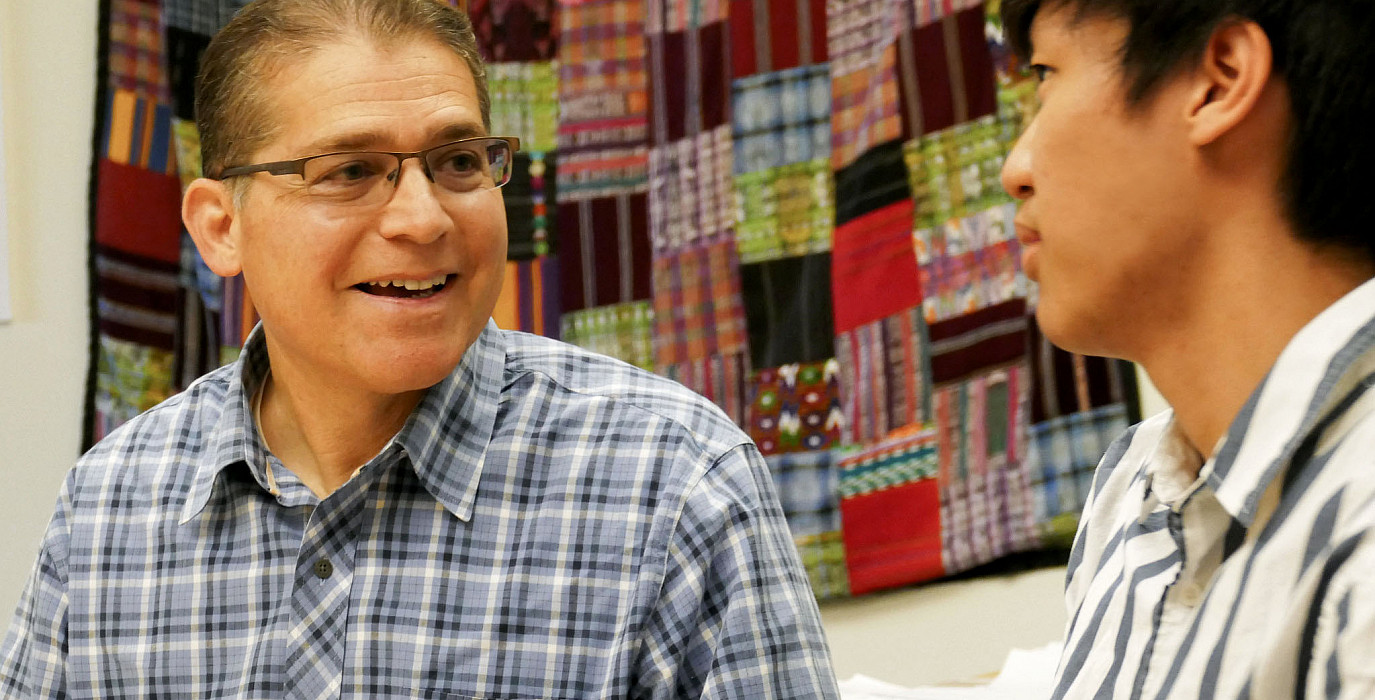 US History teacher and Global Studies Program Coordinator Peter Brown meets with a student
