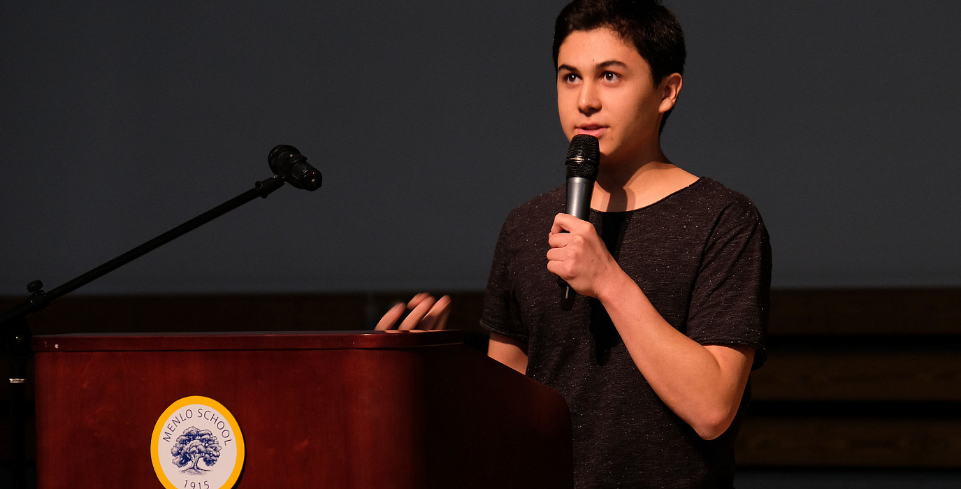 An Upper School student presents their Hand Project at an assembly.