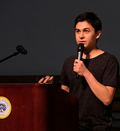 An Upper School student presents their Hand Project at an assembly.