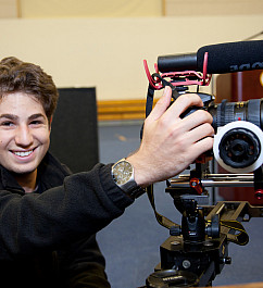 A student in Menlo's moviemaking program with a camera.