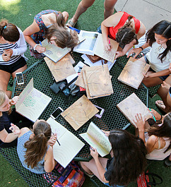 Students gather on the Quad to sign yearbooks during Day on the Green.