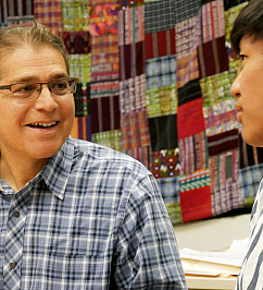 US History teacher and Global Studies Program Coordinator Peter Brown meets with a student