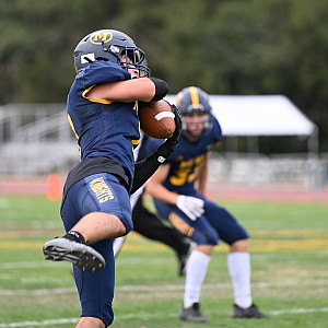 Menlo's Harry Housser pulls in a pass for a gain against Hillsdale