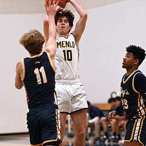 Menlo's Lucas Vogel, who had 15 points in the fourth quarter, shoots over TKA's Bryce Sherman and Tylek Barrnett.