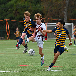Menlo's Eric Schmidtke, left, and Andre Gonzalez Lombera, who had three asissts) converge upfield in the second half of Friday's game aga...