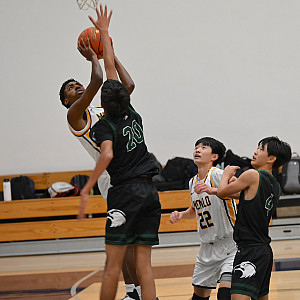 Menlo sophomore Aidan Stull finishes a reverse layup in the second quarter against Harker