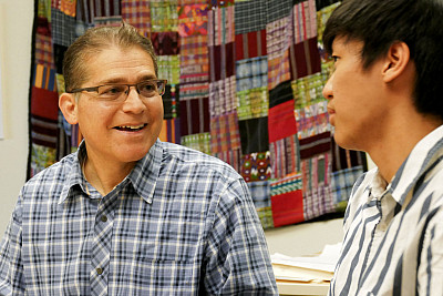 US History teacher and Global Studies Program Coordinator Peter Brown meets with a student