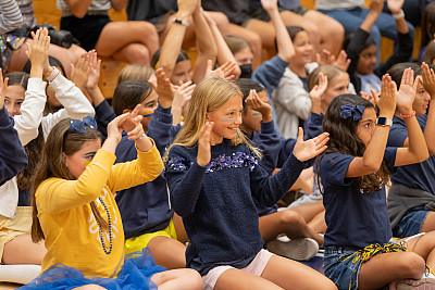 Middle School Students Cheer during an all-school assembly.