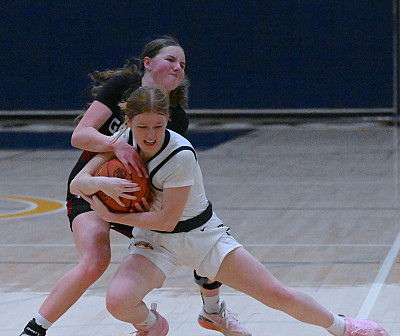 Menlo sophomore Sophie Housser fights for a loose ball against SHP