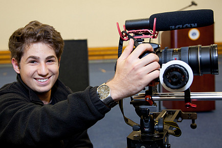 A student in Menlo's moviemaking program with a camera.