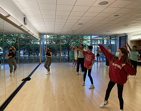 Hamilton national tour castmember Ixchel Cuellar teaches middle school dance students some new moves.