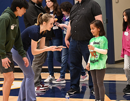 Brady Jung and Tatum Herrin talk with a student at a recent Special Olympics Field Day at Menlo