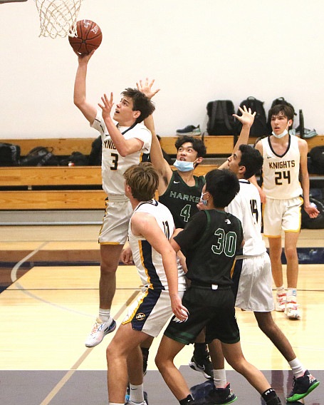 Menlo's Brooks Mead soars to the basket in the first half against Harker