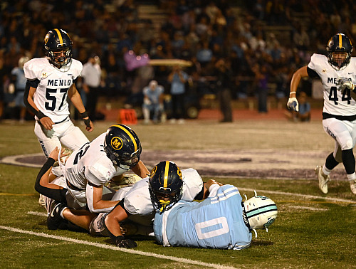 Menlo seniors Palmer Riley (52) and Chuck Wynn tackle Branham's Brayden Hodges