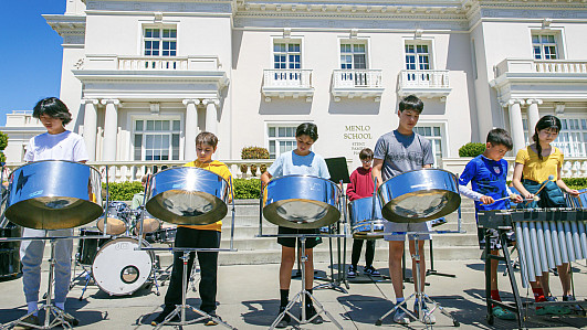 Middle School music students in the percussion class perform in front of Stent Family Hall.