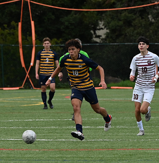 Menlo senior Alessandro Velazquez, who finished with two goals, fights for possesion against SHP in Friday's matchup.