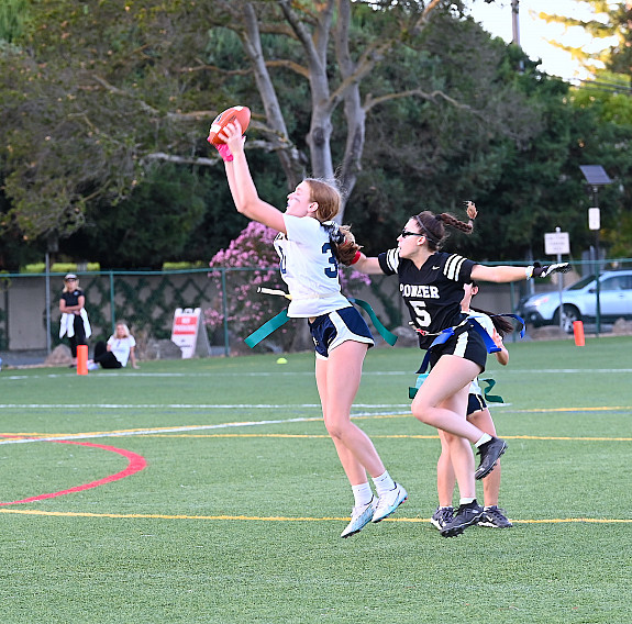 Menlo's Julia Axelrod grabs her first of two interceptions in Monday's game against Pioneer.