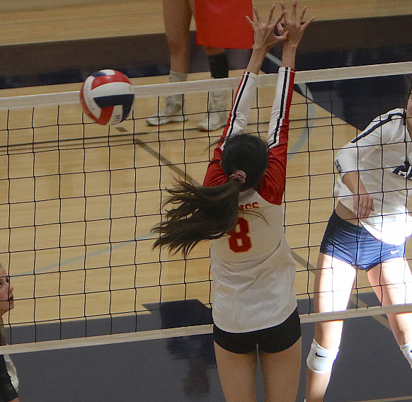 Menlo sophomore Lauren Mrva strikes in the first match against Mills on Saturday.