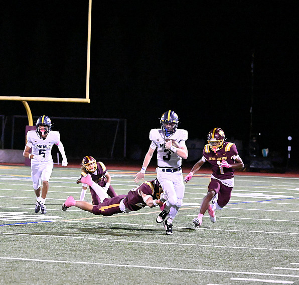 Senior quarterback Jack Freehill evades defenders for a big gain