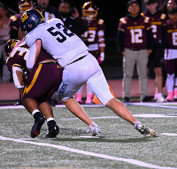 Knights senior Palmer Riley tackles M-A back Monty Turner in Friday's game