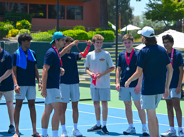 Captain Lucas Ying gives a medal to fellow senior Stefan Perkovic during Saturday's award ceremony.