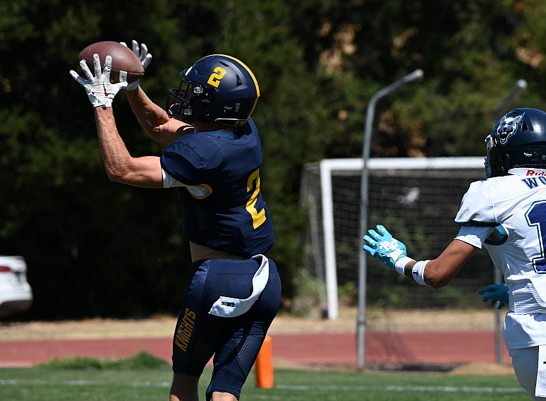 Menlo senior Trevor van der Pyl hauls in one of two touchdown passes Saturday