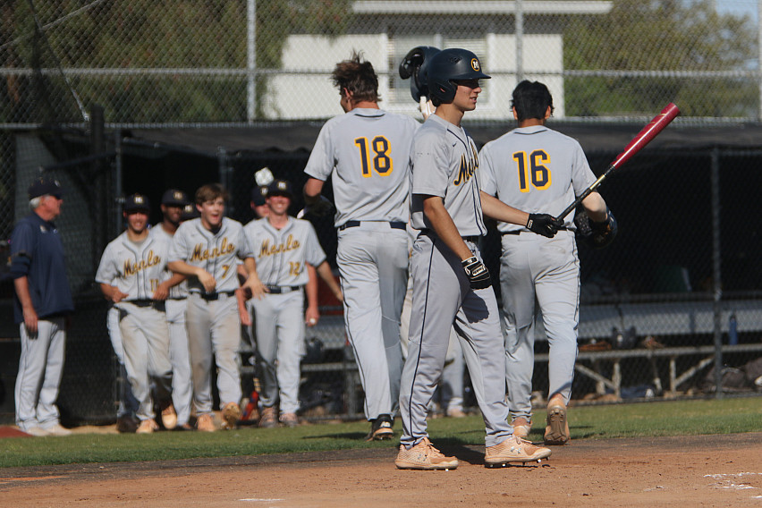 Menlo junior Jake Bianchi is greeted after his three-run home run against Woodside.