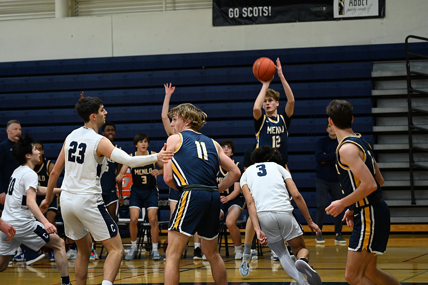 Menlo's Tate Cohen fires a shot in the fourth quarter at Carlmont on Saturday