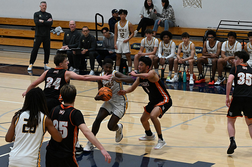 Menlo senior Aidan Stull works his way through Half Moon Bay defenders on Saturday