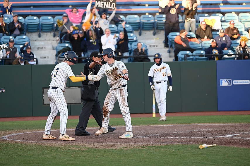 Chuck Wynn  and Jack Freehill celebrate crossing the plate on Matthew Majalya's single.