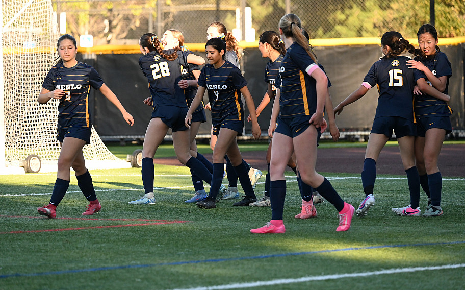 Knights senior Katie Kossow hugs sister Anna after the freshman's first prep goal  late in the second quarter
