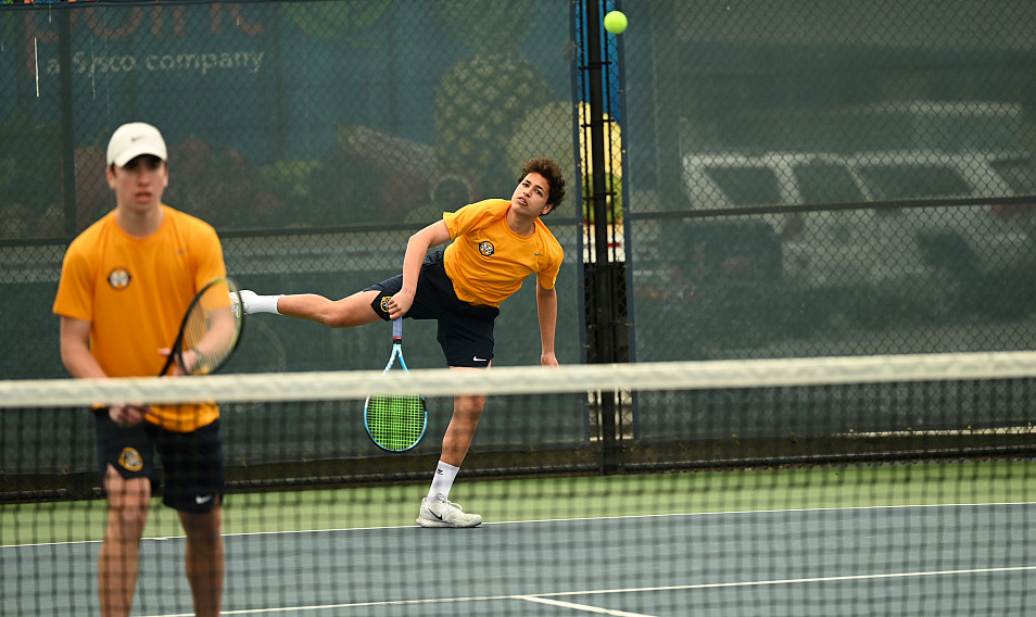 Menlo's Nikhil Agarwal (serving) and Sam Engel went 3-1 for the No. 1 doubles team.